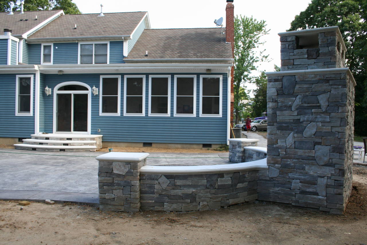 outdoor fireplace patio designed by Sanstone Creations